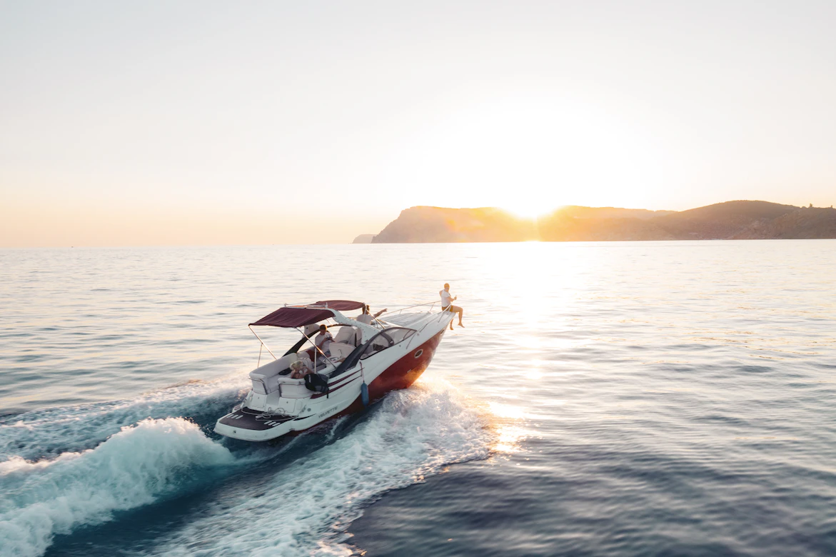 Bateau à moteur sur la mer au coucher du soleil